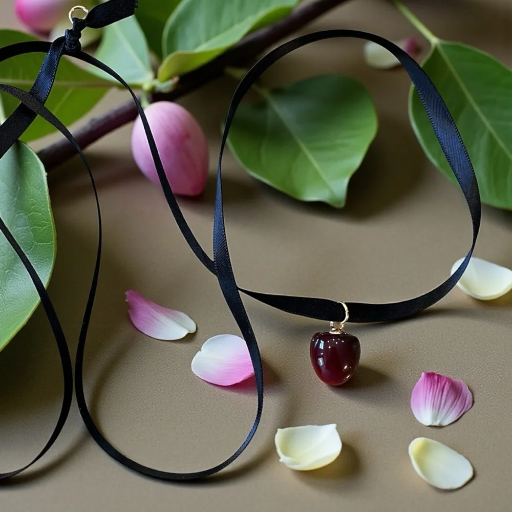Satin ribbon choker necklace featuring an apple/cherry pendant